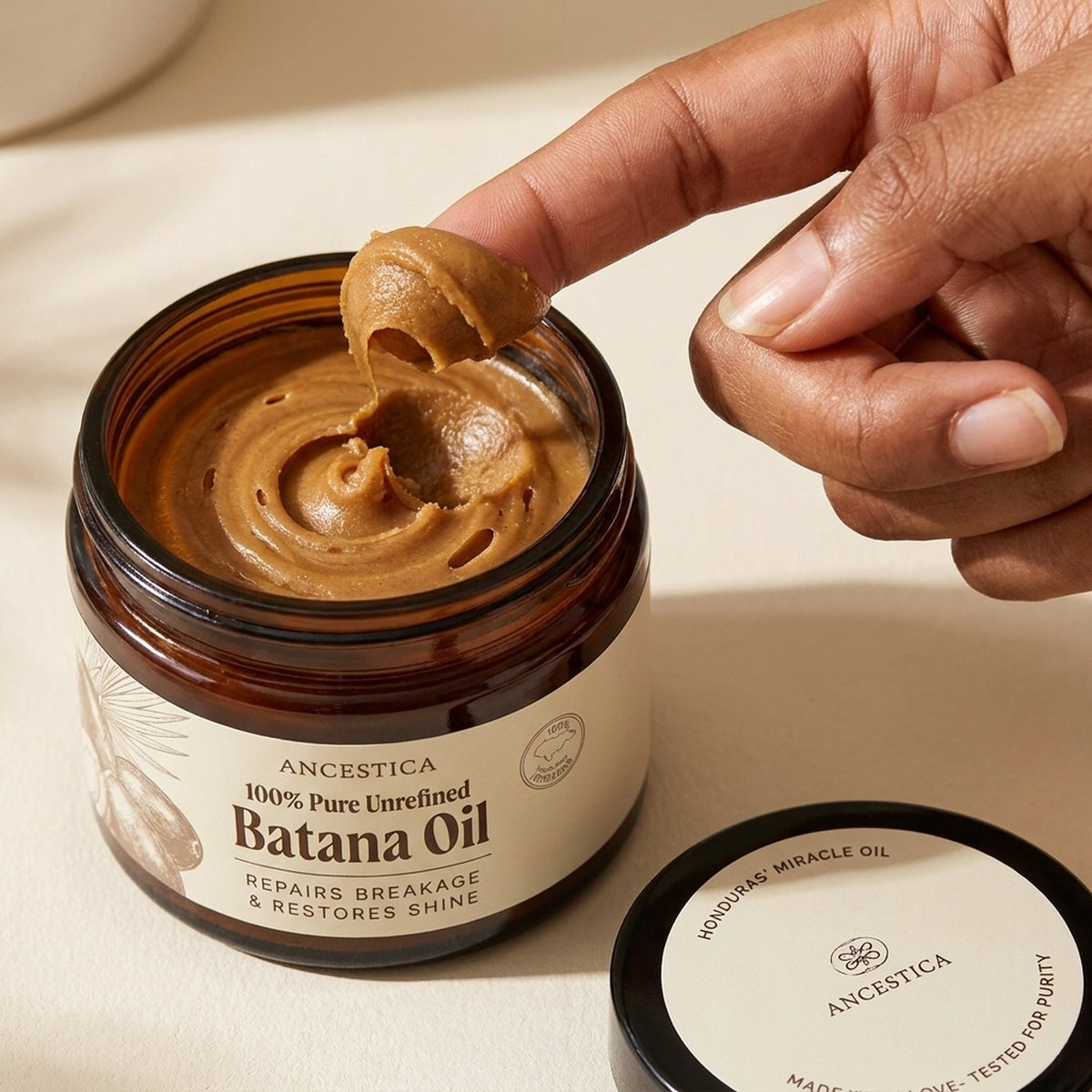 A fingertip scoop lifted from the jar, turning translucent amber as it warms